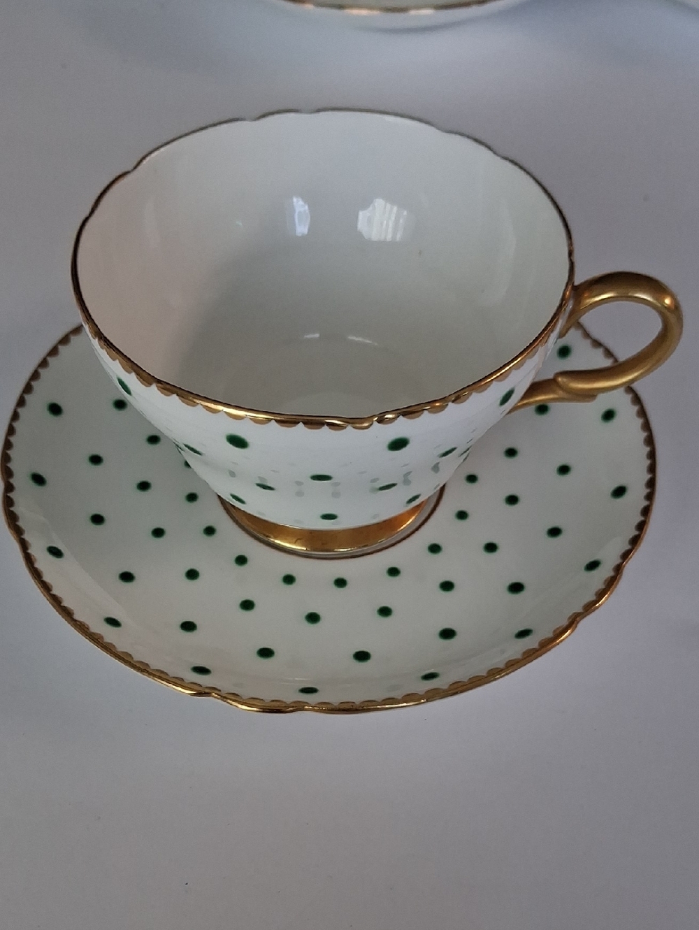 White Teacup and Saucer with Green Polka Dots and Gold Trim